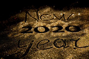 Happy New Year 2020. Beautiful sparkling Golden number 2020 on black background for design With Copy Space For Text. Beautiful Glowing overlay template for holiday greeting card