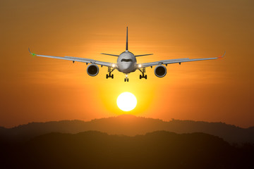 Airplane takeoff/landing at sunset