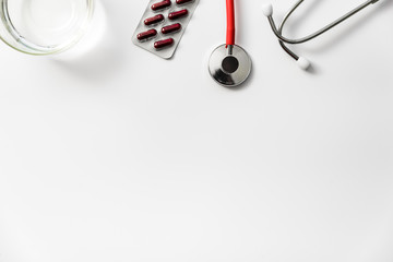 Top view of medical material that has been prescribed to take pills, and stethoscope.