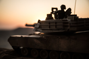 War Concept. Armored vehicle silhouette fighting scene on war fog sky background. American tank at...
