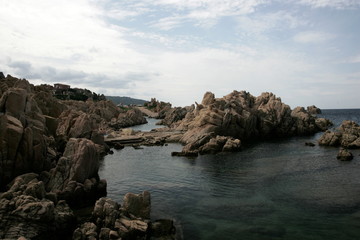 Fototapeta na wymiar rocks and blue sea, bay in Costa Paradiso, Sardinia Italy