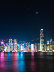Fototapeta na wymiar Victoria Harbour - Hong Kong skyline at night under the moonlight.
