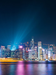 Hong Kong skyline at night with laser from the top of building.