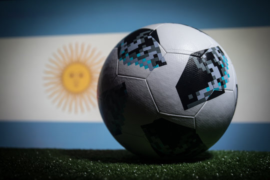 BAKU,AZERBAIJAN - JUNE 21, 2018 : Creative Concept. Official Russia 2018 World Cup Football Ball The Adidas Telstar 18 On Dark Toned Foggy Background With Flag Of Argentina.