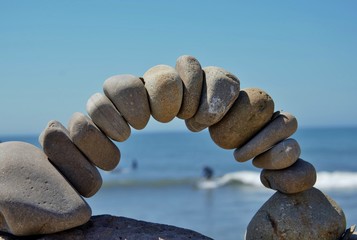 Fototapeta na wymiar stone balancing arch on beach