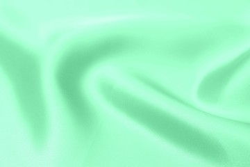 green satin fabric texture soft blur background