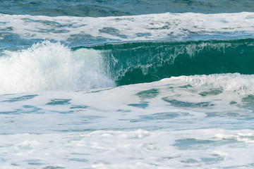 Naklejka na ściany i meble Ocean waves breaking on a windy day stock photo