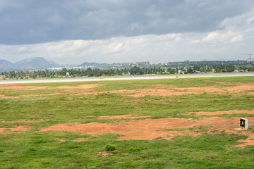 Bangalore to Pune, , a large green field with trees in the background