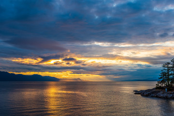 View of ocean sunset over mountains in beautiful British Columbia.