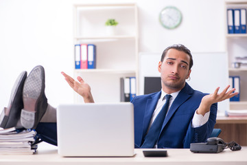 Young male businessman working in the office