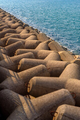 Obraz premium A waterbreaker dam beside the port at seaside