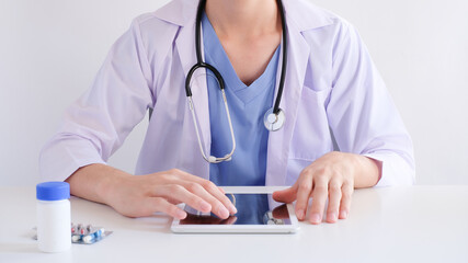 doctor using tablet for medical and clinical online searching . healthcare with technology concept