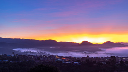 View of village covered in foggy during morning sunrise colorful sky
