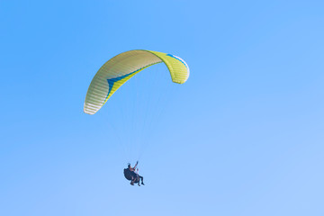 A man in a business suit experiences the thrill of flying a paraglider