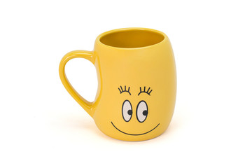 Closeup empty happy yellow smiling cup isolated on white background. Ceramics cup in bean shaped with smile face on mug. Clipping path.