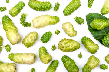 Noni fruit or Morinda citrifolia, indian mulberry, cheese fruit and sliced with green leaves pattern texture for background.
