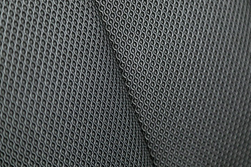 Part of   car headrest seat details. Сlose-up black perforated   textile car seat. fabric texture