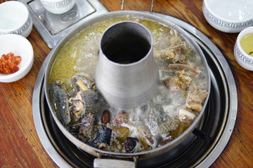 Lijiang Preserved Spare Ribs Hotpot, Yunnan. Yunnan-style hot pot broth is clear and light, bubbling with choice of smoked pork ribs or chicken.