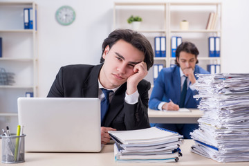 Two male colleagues unhappy with excessive work