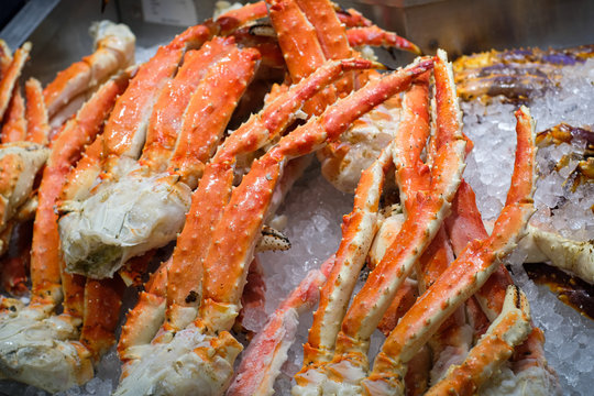 Close up of big giant King crab legs on ice selling at market , food and travel concept.