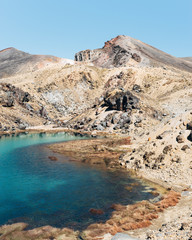 Emerald lake front view with volcano at the background