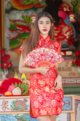 Fototapeta na wymiar Portrait of beautiful asian woman in Cheongsam dress,Happy Chinese new year concept