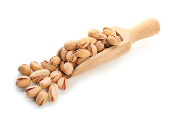Scoop with tasty pistachio nuts isolated on white