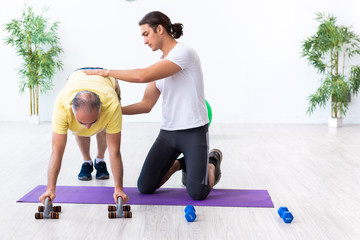 Old man doing exercises indoors