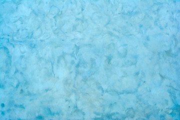 Old wall of a building covered in light blue paint