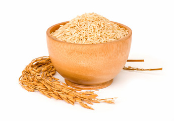 Brown coarse rice,natural long rice grains (Thai jasmine rice) in wooden bowl and paddy rice isolated on white background. Healthy food and diet concept.Space for text.