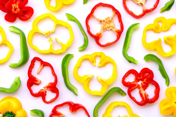 Fresh slices of yellow bell pepper in ring shaped on white background. Top view.