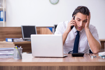 Young male businessman working in the office