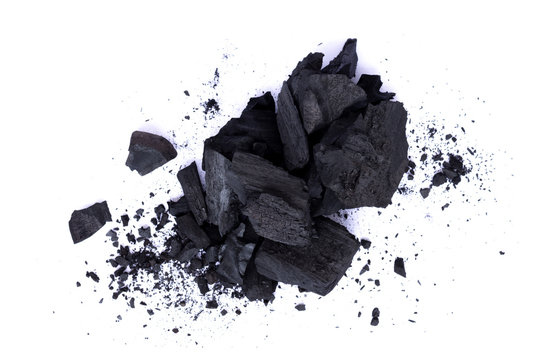 Pile of natural broken black activated charcoal granular and powder isolated on white background.