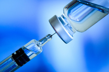 Close up of flu and measles vaccine vials for baby caccination, medicine and drug concept