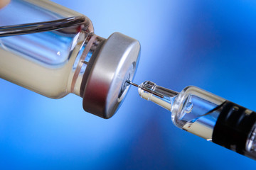 Close up of flu and measles vaccine vials for baby caccination, medicine and drug concept