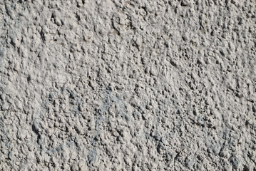 Texture of a wall plastered with cement painted in gray