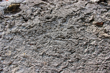 Texture of an old damaged wall coated with thick layer of cement