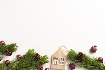 Spruce branches with small wooden house, on a white background. Christmas, winter concept. Flat...