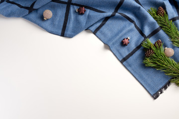 Winter cozy composition. Warm plaid with christmas decoration, on a white background. Flat lay, top view, copy space.