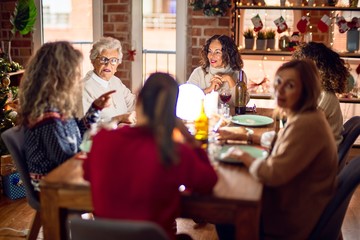 Beautiful group of women smiling happy and confident. Eating roasted turkey celebrating christmas at home