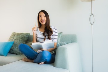 Portrait beautiful young asian women reading book with coffee cup