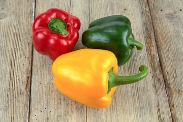 peppers of many colors on a wooden table