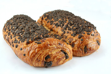 two chocolate buns on a white background