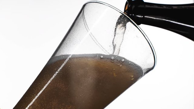 Pouring yellow beer on white background. Barm, bubble fresh drinking, foamy golden alcohol.