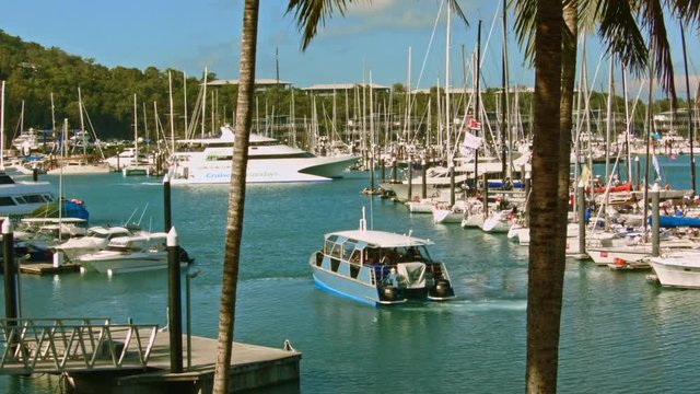 Small ferry taking passengers out of busy marina