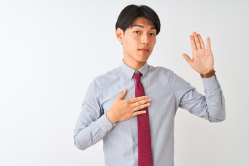 Chinese businessman wearing elegant tie standing over isolated white background Swearing with hand on chest and open palm, making a loyalty promise oath