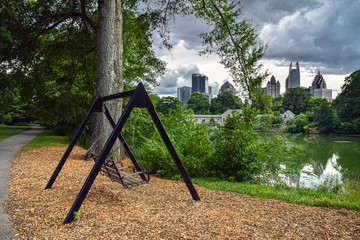 Bench Swing by Lake in Piedmont Park and Skyline of Downtown Atlanta in Background - Atlanta,...