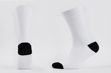 Blank white cotton long sock with black heel on  invisible foot on white background as mock up for...