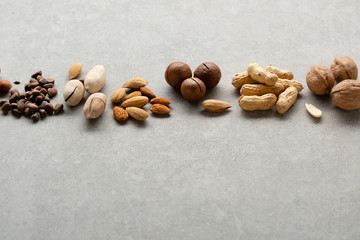 Gray food background with nuts mix and copy space