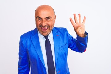 Middle age businessman wearing suit standing over isolated white background showing and pointing up with fingers number four while smiling confident and happy.